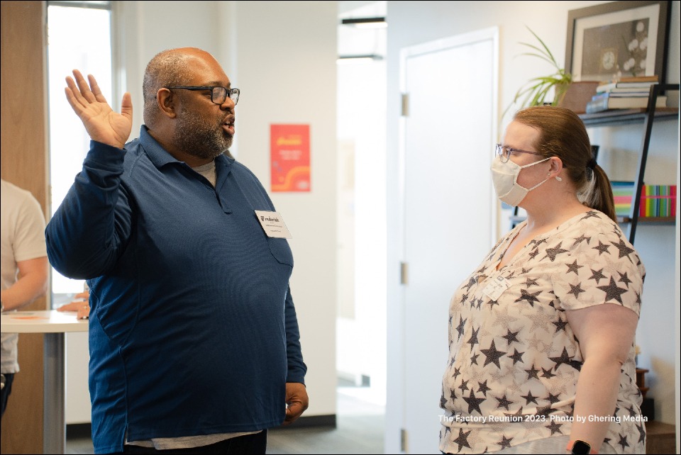 Factory members, current and former discussing the new space.